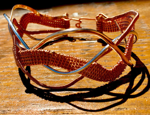 Copper, silver, and bronze wire are woven together and braided in a wavy pattern in this 7.5
