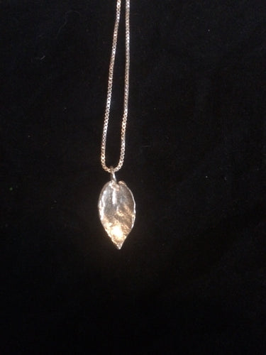 This fine silver pendant is molded from the imprint of a black mangrove leaf, and comes with an 18