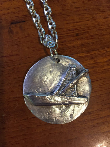 This fine silver pendant is molded to depict a specific make and model of boat. Part of our custom boat portraist series, this piece shows our capability to manufacture a pendant bespoke to a specific vessel. Details are taken from photographs and boat plan drawings. Any vessel can be portrayed--come visit our special section at https://www.kalmansoncreations.com/boats on our independent website for more information!