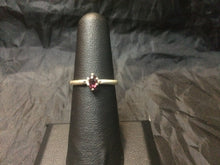 Load image into Gallery viewer, A 5x3mm natural rhodolite gemstone is set into a beefy USA-made sterling silver ring mounting. This ring is approximately a size 6.