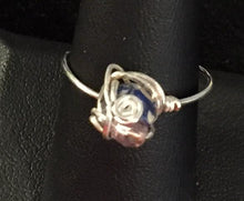 Load image into Gallery viewer, A 6mm reconstituted and dyed shell round bead is set with a swirl and a purple glass seed bead into this sterling silver wire wrapped ring. Rings made by this wire wrapping method vary individually. This one is approxmately a size 8.