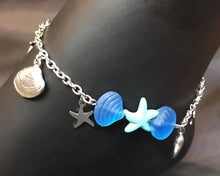 Load image into Gallery viewer, Brilliant blue Czech pressed glass beads shaped like clamshells surround a bright blue pressed glass sea star, accented by delicate stainless steel charms on a sturdy stainless steel chain in this rust-resistant anklet that can stay with you throughout all your adventures.