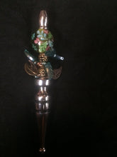 Load image into Gallery viewer, The design theme for this bottle stopper uses plated metal and glass leaves to form base of a flower bush represented by a large glass bead.åÊ The cental stalk of the bush uses more metal beads.
