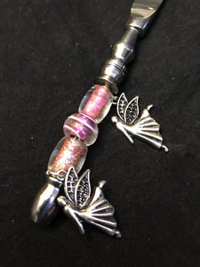 Tiny fairies fly between rosy pink blown glass beads on this dreamy butter knife handle.