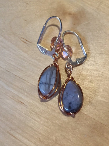 Greyish agate stones ensconced in copper wire and mounted on silver plated brass lever back earwires, accented with a faceted glass crystal. 