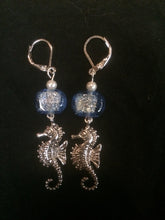 Load image into Gallery viewer, A pair of 10mm dichroic glass beads accent silver plated pewter seahorse charms below silver plated brass leverbacks.