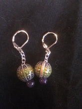 Load image into Gallery viewer, A pair of purple sea urchin mood beads that change color with temperature sits on silver plated chain below silver plated brass leverbacks.