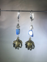 Load image into Gallery viewer, Leverback earrings made from plated metal charms and findings with an 8mm lapis lazuli bead to add a vibrant blue color.