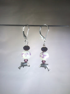 Leverback earrings with a metal leaping dolphin charm and Swarovski crystal beads.