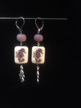 Load image into Gallery viewer, Leverback earrings made from plated metal charms and ceramic beads in a purple tone.