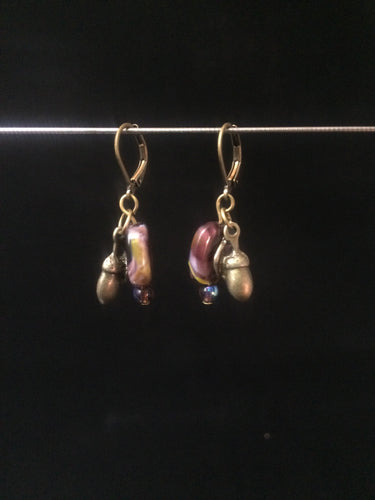 Leverback Earrings made from purple blown glass beads that have swirls and metal acorn charms.åÊ Round glass pearls are added for accent.