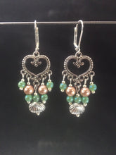 Load image into Gallery viewer, Leverback chandelier earrings made with glass pearls, metal beads, and metal shell charms.