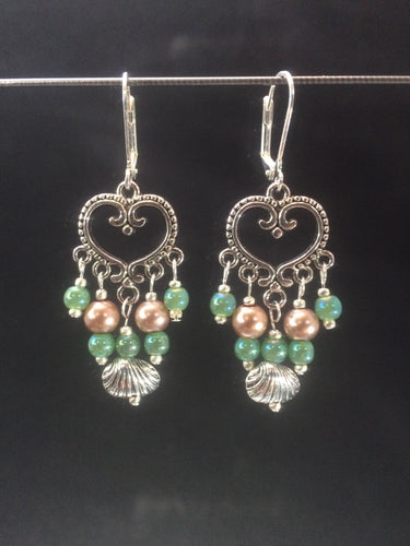 Leverback chandelier earrings made with glass pearls, metal beads, and metal shell charms.