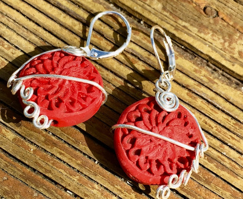 Carved soapstone rosettes are accented by delicate sterling silver wirework,  then mounted on 925-stamped sterling silver leverbacks.