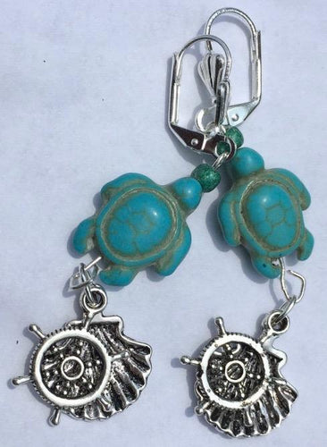 Dyed magnesite beads carved into the shape of sea turtles form the focus of these silver plated brass leverback earrings. Metal oyster and wheel charms complete the look.