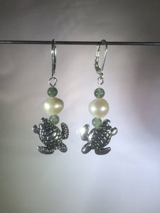 Metal beads shaped like diving sea turtles are accented by aventurine and glass pearl beads in these silver plated brass leverback drop earrings.