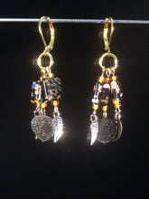 Load image into Gallery viewer, These chandelier-styleåÊleverbackåÊearrings featureåÊ10mm square black millefiore beads with shiny leaf charms dangling below, for a total dangle length of about 1.5&quot;. Forms a matching set with necklace 1NCK0059.
