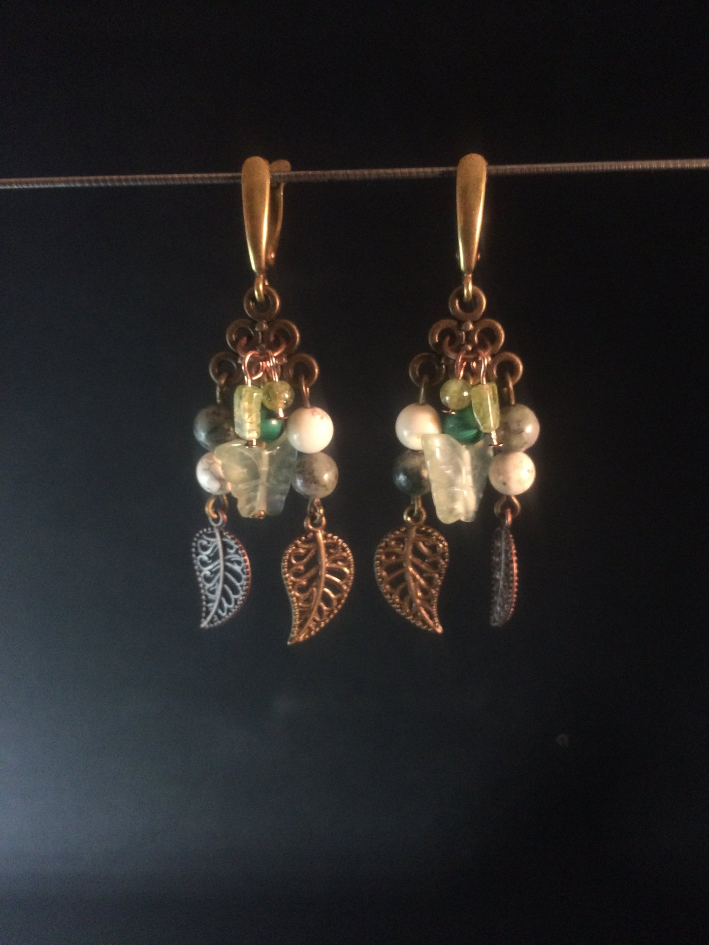 A necklace and set of leverback earrings made from glass beads, gemstone beads, and metal charms on chandelier findings. Forms a matching set with necklace 1NCK0058.