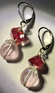 Red glass cubes support delicate pink glass ovals, interspersed with diamond-cut sterling silver wire in these 1.5" drop sterling silver leverback earrings.