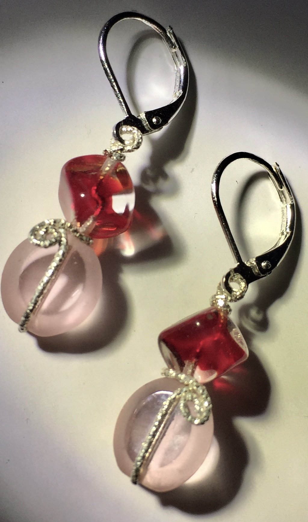 Red glass cubes support delicate pink glass ovals, interspersed with diamond-cut sterling silver wire in these 1.5