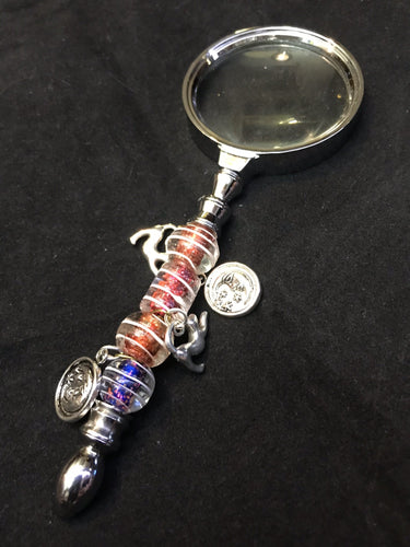 Cat charms dance under the moonlight against a backdrop of blown glass beads on the handle of this magnifying glass.
