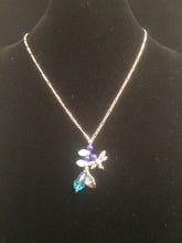 Load image into Gallery viewer, Necklace set with a lily theme accented with blue glass beads and blue faceted beads and metal charms. Forms a matching set when purchased with earrings 1EAR0136.