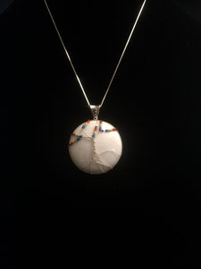 This tree of life uses the inclusive rainbow as the color theme made with glass seed beads on fine silver wire on a silver chain. The background is a cabochon of Mountain Jade (dolomite marble) which has been dyed to its color.