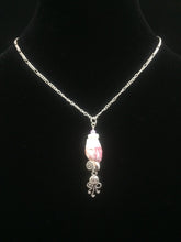 Load image into Gallery viewer, A barnacle sourced locally in St. Augustine Beach is accented by silver plated charms and glass beads, then mounted on a 16&quot; silver tone steel chain.