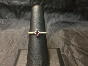 A 5x3mm natural rhodolite gemstone is set into a beefy USA-made sterling silver ring mounting. This ring is approximately a size 6.