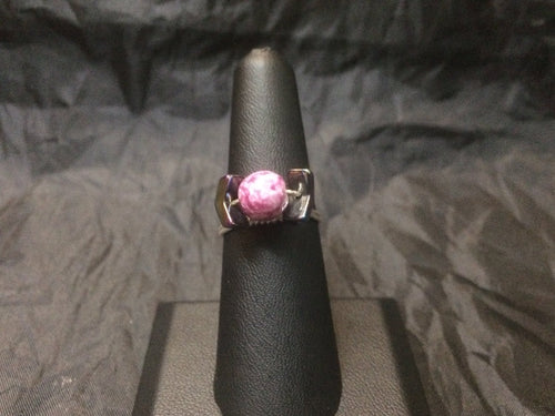 A 6mm round painted ceramic bead is flanked by twin chevron-shaped hematite beads, giving the overall impression of the shape of a particularly famous science fiction fighting spacecraft. Sterling silver wire holds the design together in this unique ring. Rings made by this wire wrapping method vary individually. This one is approxmately a size 6.