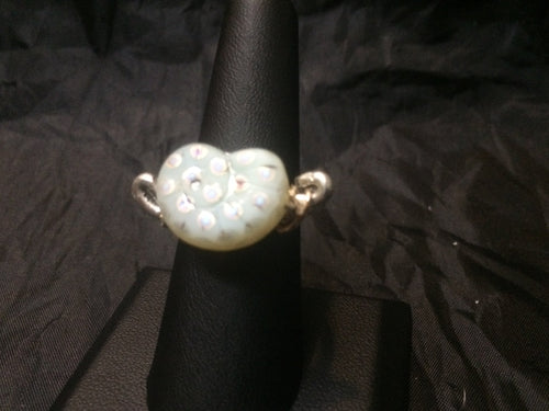 A 17x13mm cardoid shaped lampworked glass bead is set with opposing swirls onto this silver plated copper wire wrapped ring. Rings made by this wire wrapping method vary individually. This one is approxmately a size 6.