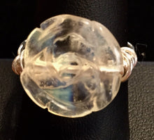 Load image into Gallery viewer, An opalite bead carved to resemble a rose is wrapped in fine silver with coils at the side for stability in this ring. Rings made by this wire wrapping method vary individually. This one is approxmately a size 8.25, but may fit a slightly larger finger depending on how snug a fit you prefer.