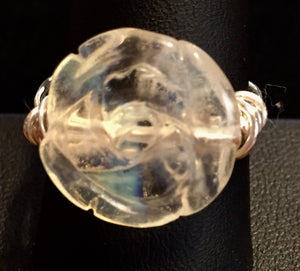 An opalite bead carved to resemble a rose is wrapped in fine silver with coils at the side for stability in this ring. Rings made by this wire wrapping method vary individually. This one is approxmately a size 8.25, but may fit a slightly larger finger depending on how snug a fit you prefer.